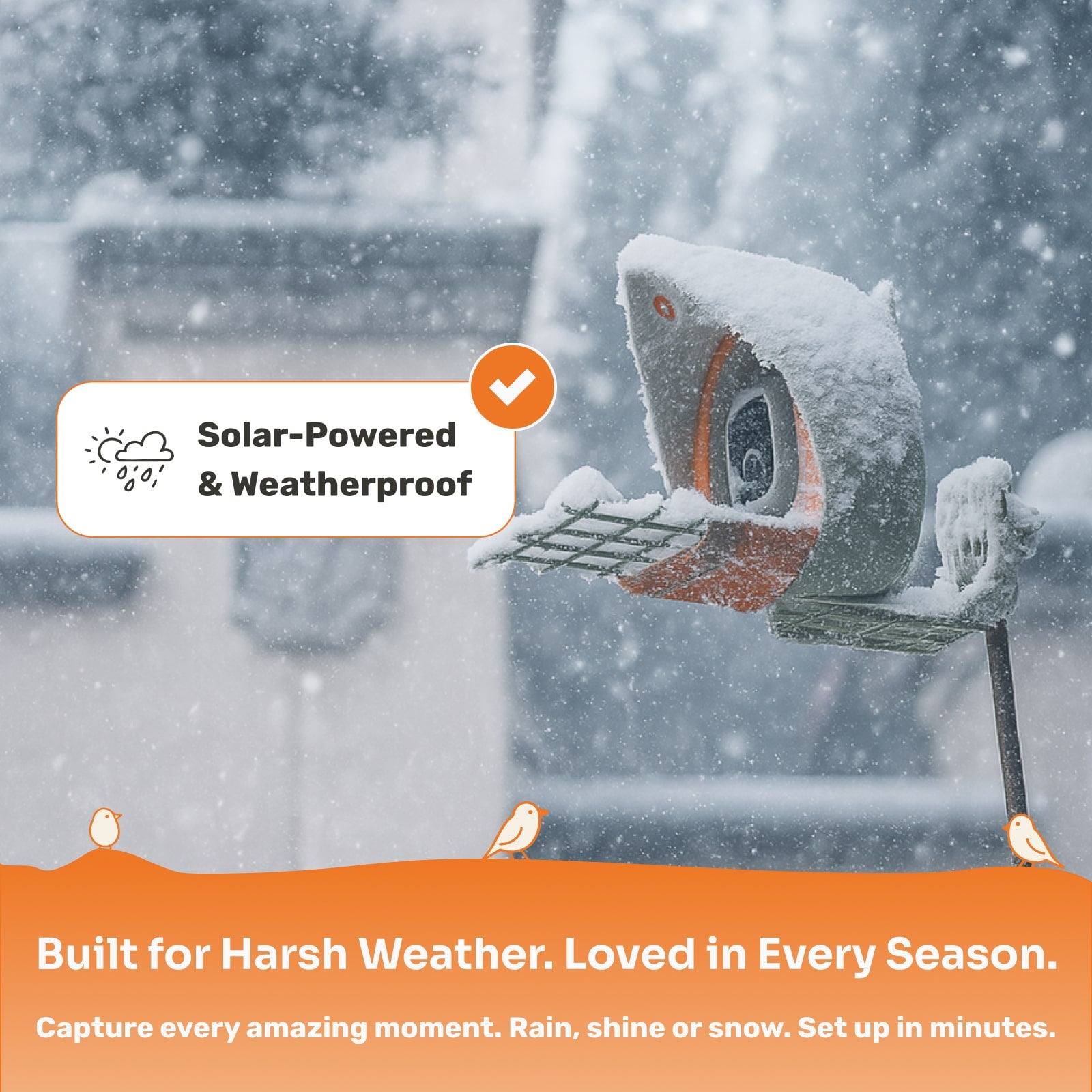 Bird feeder covered in snow with solar-powered and weatherproof label, set against a snowy background.